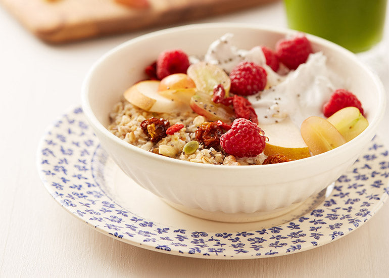 A bowl of oatmeal mixed and topped with Navitas Organics plant-based superfoods.