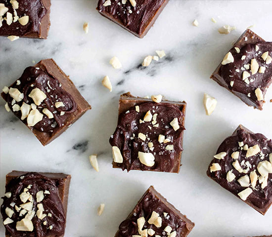 Freezer fudge bars topped with cashews and made with Navitas Organics Cacao