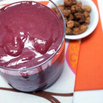 Purple smoothie with dish of mulberries made with Navitas Organics Mulberries, Acai Powder and Camu Powder