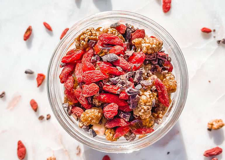 Overnight berry oats made with Navitas Organics Chia Seeds, Hemp Seeds and Maca Powder, topped with Navitas Organics Goji Berries, Mulberries and Cacao Nibs
