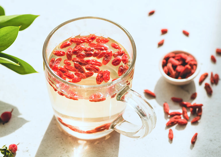 A glass of tea made with Navitas Organics Goji Berries