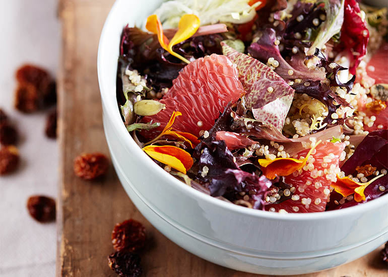 A citrusy summer salad topped with a dressing made with Navitas Organics Goldenberries