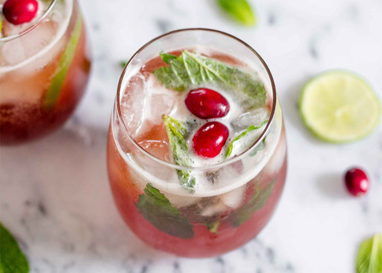 A cranberry pomegranate mojito drink made with Navitas Organics Pomegranate Powder