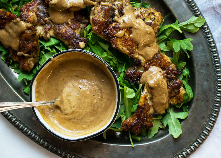 A platter of meat-free tenders drizzled with a Romanesco sauce made with Navitas Organics Cacao Butter.
