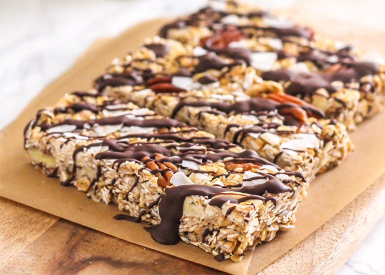 A row of maca cashew trail mix bars made with Navitas Organics Maca Powder, Cashews and Chia Seeds on a cutting board.