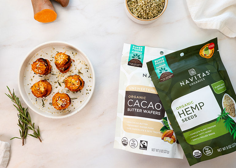 A plate of sweet potato stacks made with Navitas Organics Cacao Butter Wafers, sprinkled with Navitas Organics Hemp Seeds.