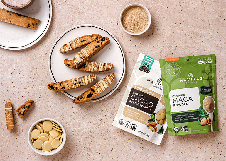 A plate of cranberry white chocolate biscotti made with Navitas Organics Cacao Butter Wafers and Maca Powder.