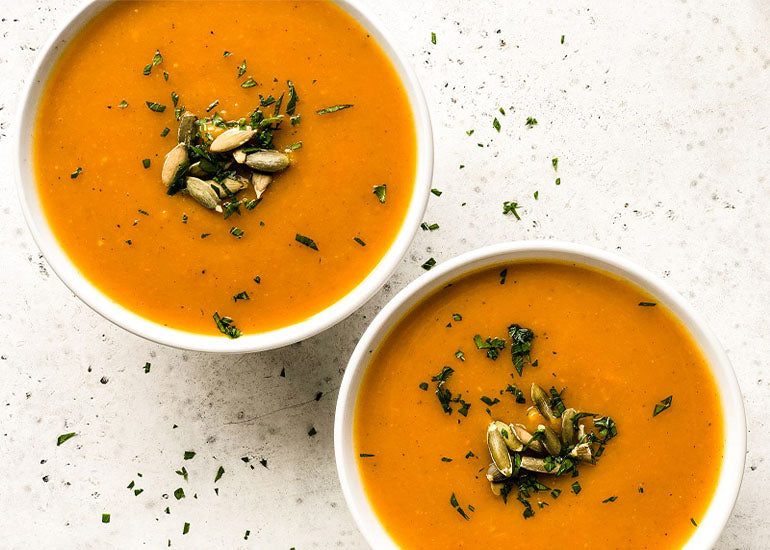 A bowl of ginger turmeric butternut squash soup made with Navitas Organics Turmeric Powder