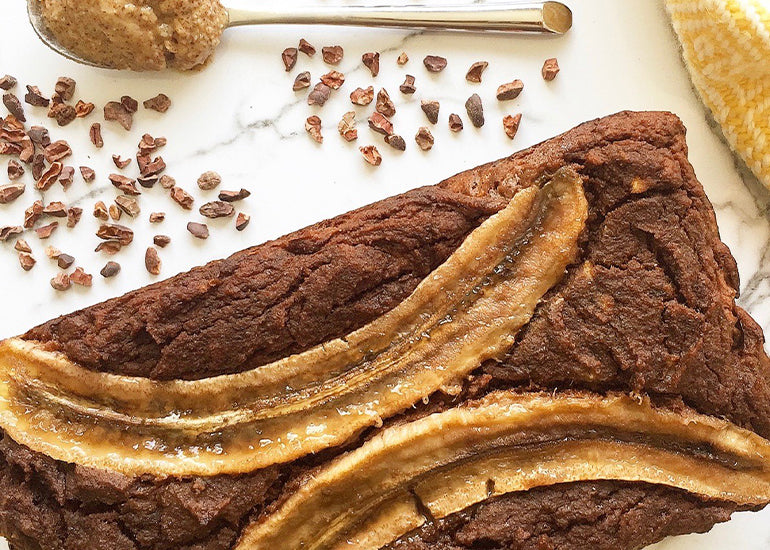 A loaf of coconut banana bread made with Navitas Organics Maca Powder, Hemp Seeds and Cacao Nibs.