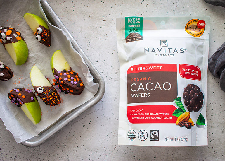 Halloween-inspired chocolate-dipped apple slices made with Navitas Organics Bittersweet Cacao Wafers