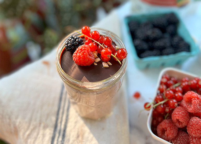 Almond butter overnight oats topped with a chocolate magic shell made with Navitas Organics Bittersweet Cacao Wafers.