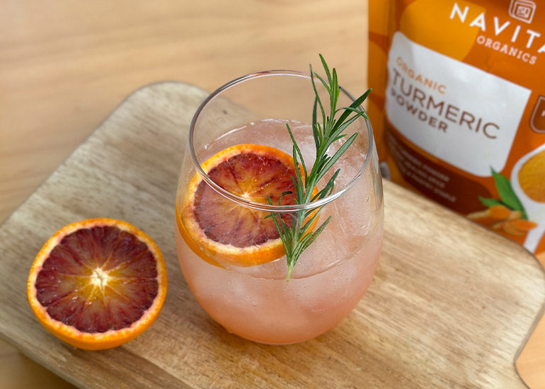 A blood orange ginger turmeric mocktail made with Navitas Organics organic turmeric powder.