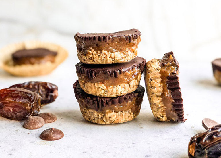 A stack of vegan date oat cups made with Navitas Organics Chia Seeds and Semi-sweet Cacao Wafers