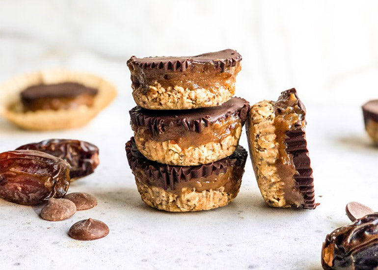 A stack of vegan date oat cups made with Navitas Organics Chia Seeds and Semi-sweet Cacao Wafers