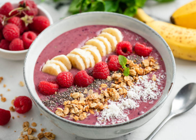 An acai bowl made with Navitas Organics Acai Powder, topped with Navitas Organics Hemp Seeds and Chia Seeds, fresh berries, granola, and desiccated coconut