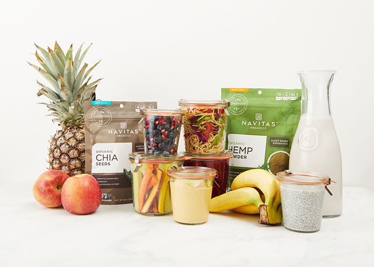 Fruits, Vegetables, Navitas Organics Chia Seeds and Navitas Organics Hemp Seeds on a kitchen counter.