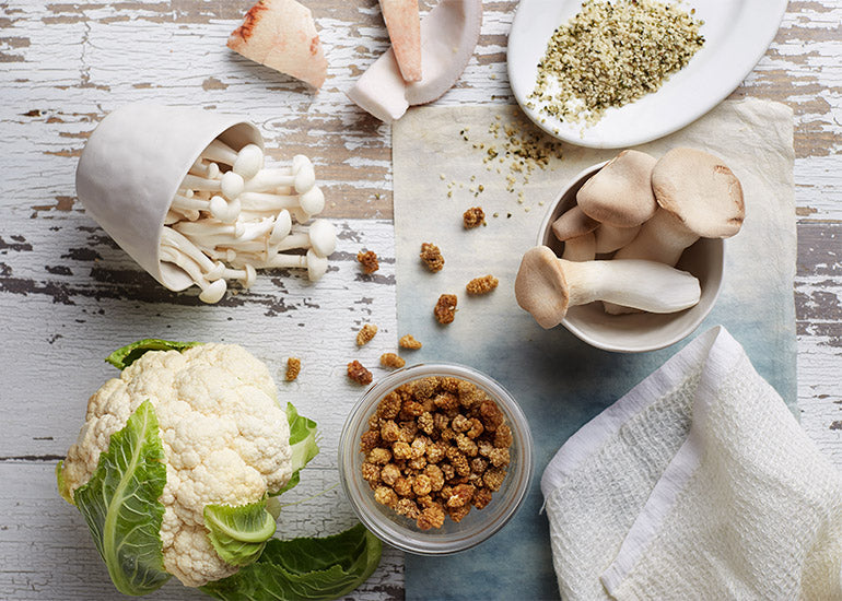 A spread of cauliflower, mushrooms, coconut, Navitas Organics Hemp Seeds, and Navitas Organics Mulberries