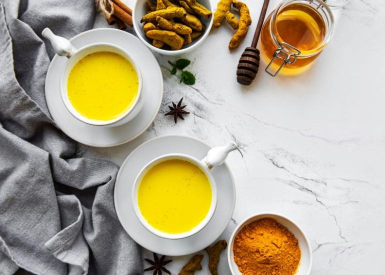 Two mugs filled with tea made with Navitas Organics Turmeric Root Powder