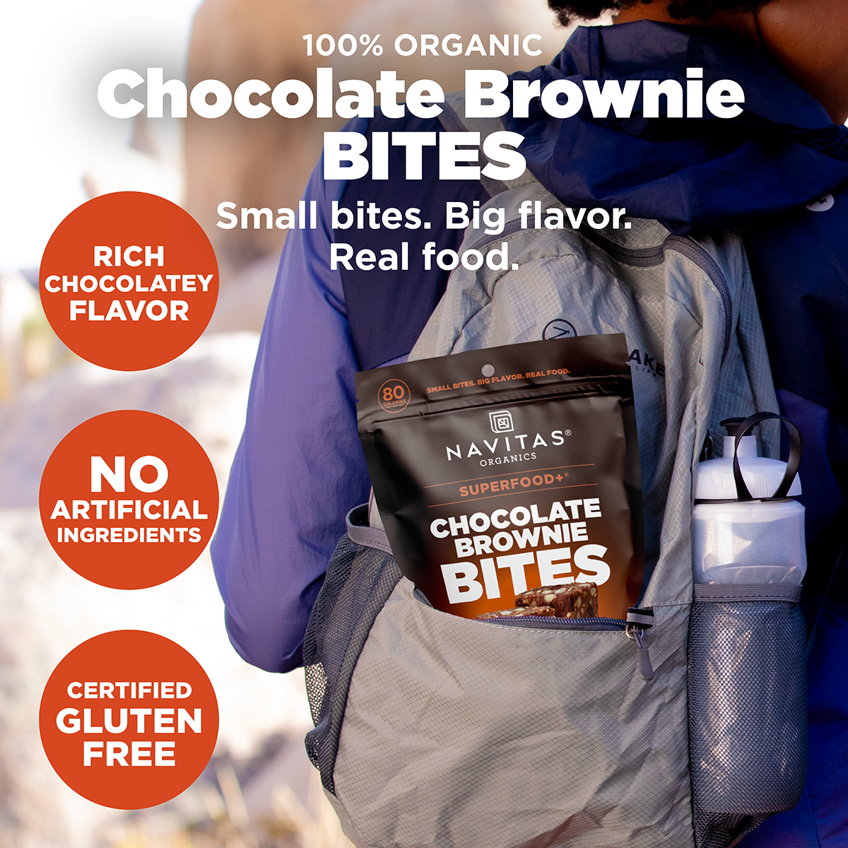 Navitas Organics Superfood+ Chocolate Brownie BITES package in a backpack with promotional text.