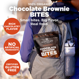 Navitas Organics Superfood+ Chocolate Brownie BITES package in a backpack with promotional text.