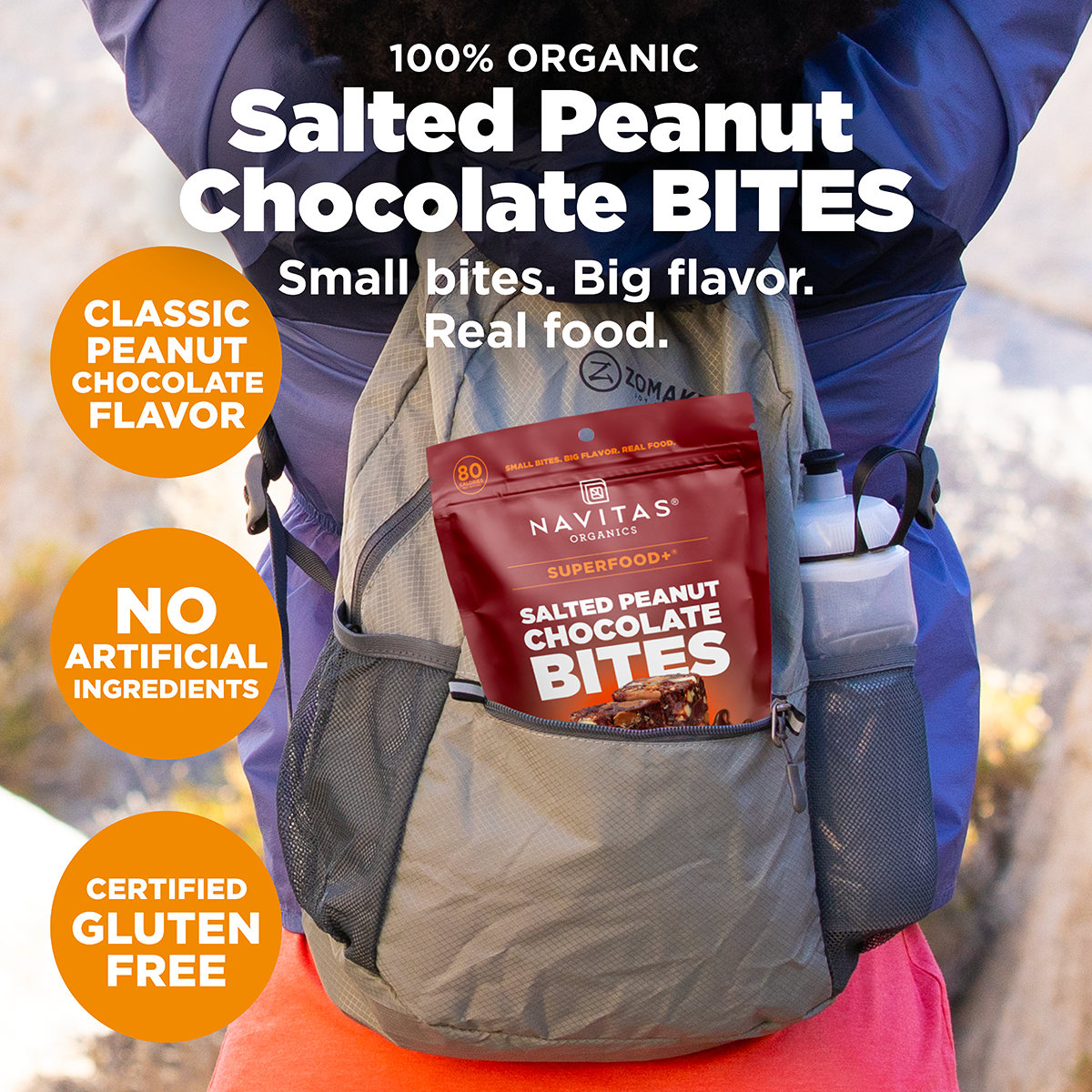 Advertisement for Navitas Organics Salted Peanut Chocolate Bites showing a pack of the product in the back pocket of a hiker's backpack. Features claims of organic ingredients, big flavor, and no artificial ingredients, certified gluten-free.