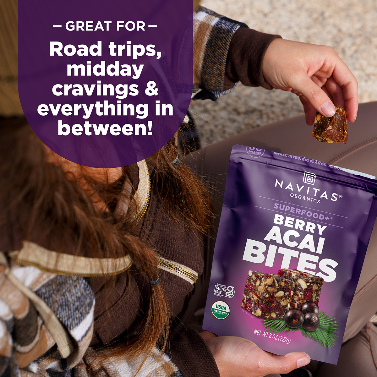 Person holding a package of Navitas Organics Berry Acai Bites with text about its uses.