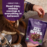 Person holding a package of Navitas Organics Berry Acai Bites with text about its uses.