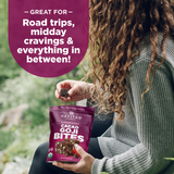 Person holding Navitas Cacao Goji Bites with text about uses