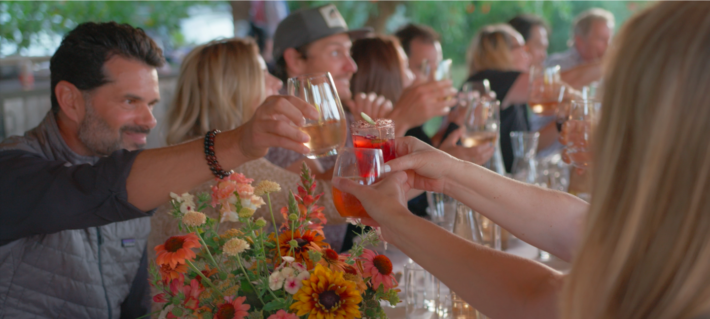 Navitas Organics team raising their glasses together.