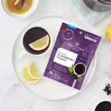 Cup of Elderberry tea with a lemon and honey with package of Navitas Elderberry powder alongside on the counter.
