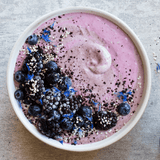 Delicious breakfast bowl with blueberries and blackberries made with Navitas Elderberry Powder.
