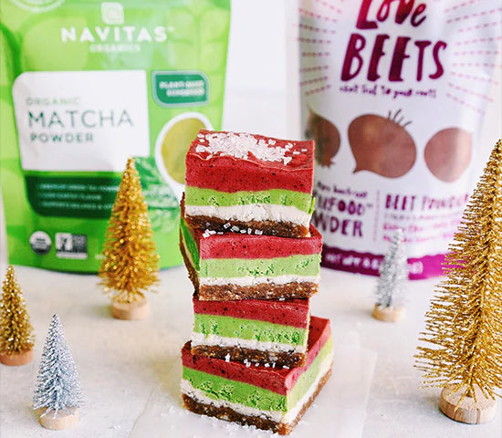 Stack of triple layer cheesecake bars made with Navitas Organics Matcha and Love Beets powder