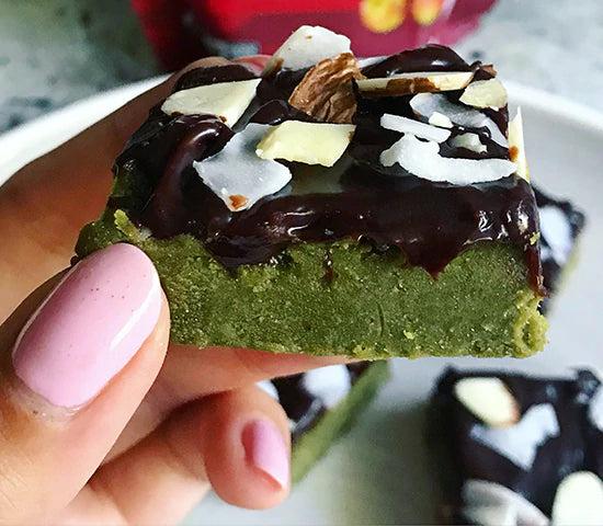 Green energy protein bar topped with cacao and coconut and made with Navitas Organics Camu Powder