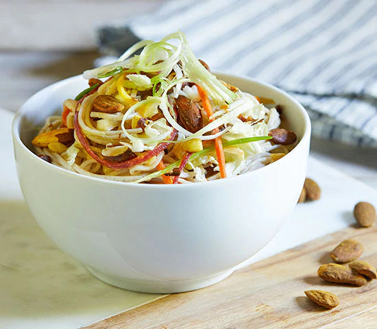 Soba noodle bowl topped with veggie strips and almonds