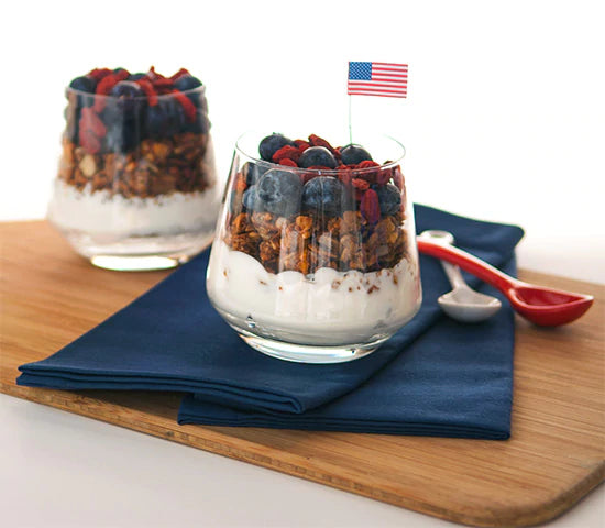 Two glass cups with dairy-free yogurt parfait, superfood berries and gluten-free granola