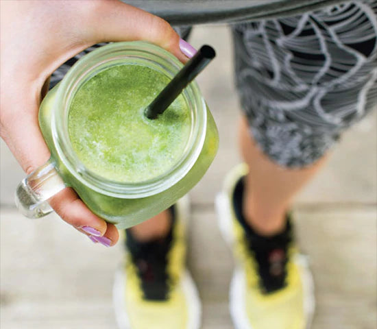 Runner holding a green smoothie made with Navitas Organics superfoods