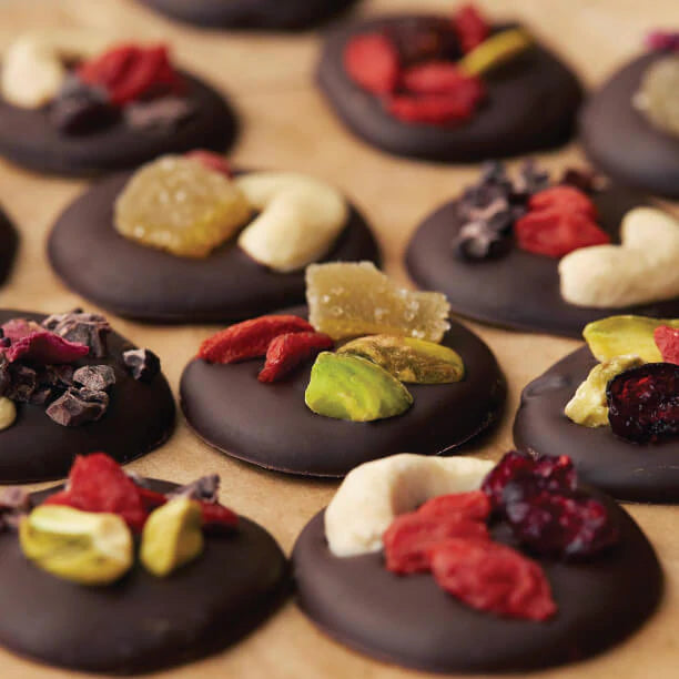 Chocolate mendiants topped with Navitas Organics Goji Berries, Goldenberries and cashews.