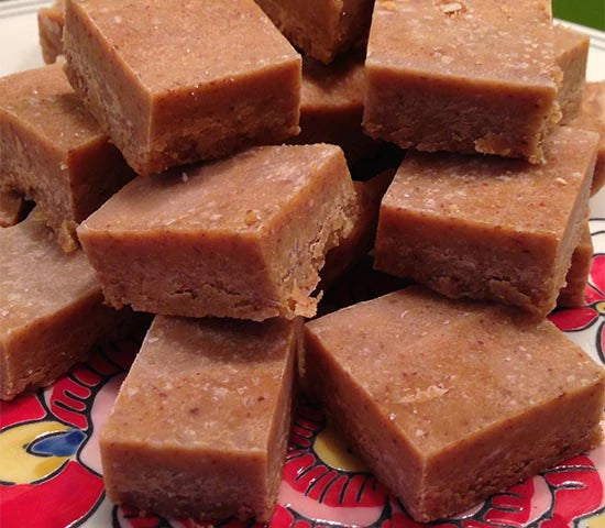 Plate stacked with squares of pumpkin fudge made with Navitas Organics Cacao Wafers and Cacao Butter
