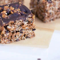 Vegan rice crispy treats made with maca powder and coated with melted chocolate