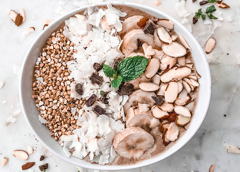 A smoothie bowl made with Navitas Organics Chia Seeds, and Hemp Seeds, topped with a variety of plant-based toppings