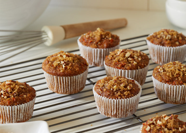 Muffins made with Navitas Organics Chia Seeds, dried fruit and chopped nuts on a cooling rack
