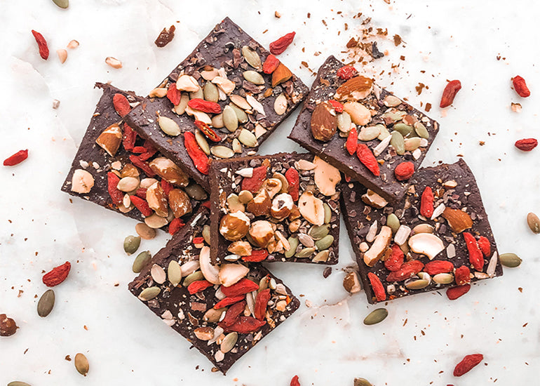 Cacao almond bars made with Navitas Organics Cacao Powder, Goji Berries and Cacao Nibs, along with a variety of seeds and nuts