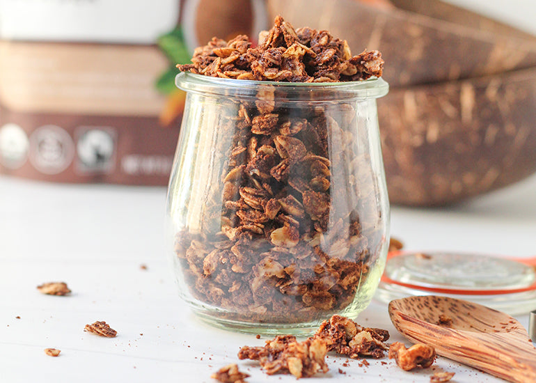 A glass filled with granola made with Navitas Organics Cacao Powder and other plant-based ingredients