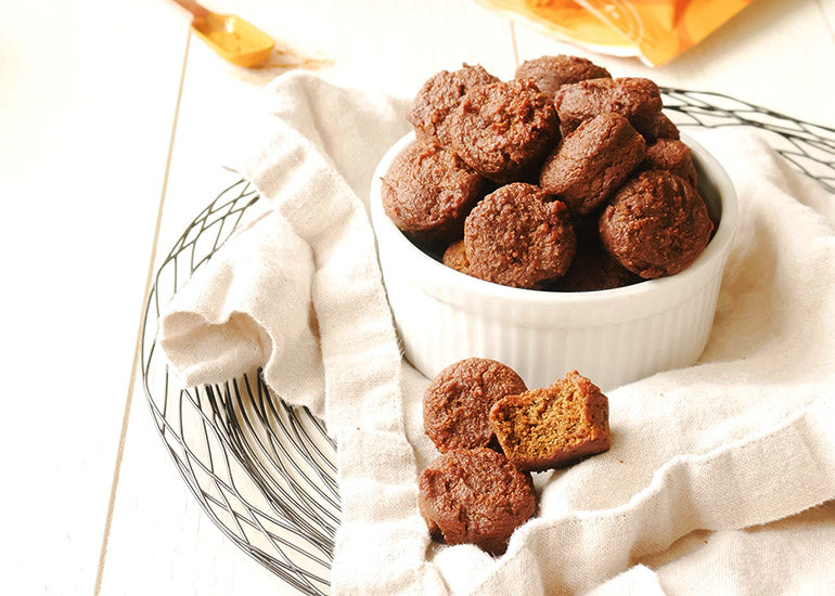 A dish filled with mini muffins made with Navitas Organics Grain-Free Flour, Superfood+ Immunity Blend and Turmeric Powder