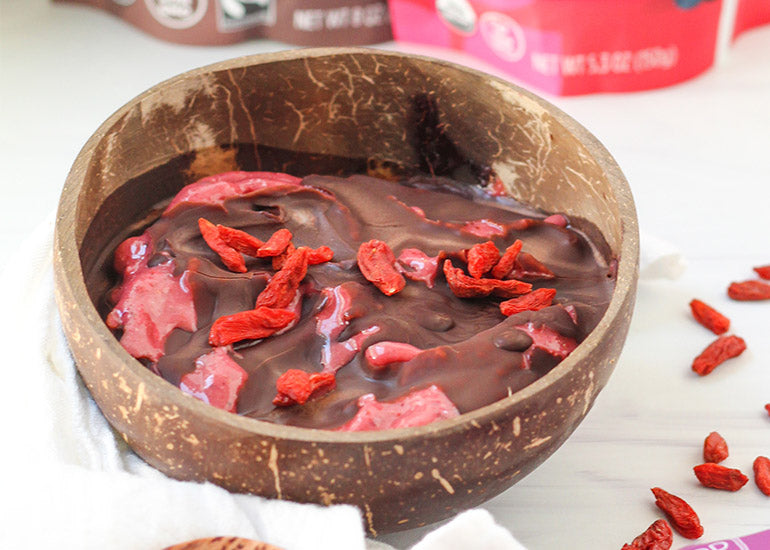 A chocolate berry smoothie bowl made with Navitas Organics Superfood+ Berry Blend, Cacao Powder and Hemp Seeds, topped with Navitas Organics Goji Berries