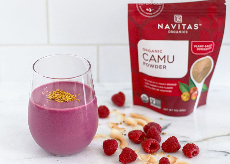 A raspberry beet smoothie made with Navitas Organics Camu Powder and Hemp Seeds, topped with bee pollen