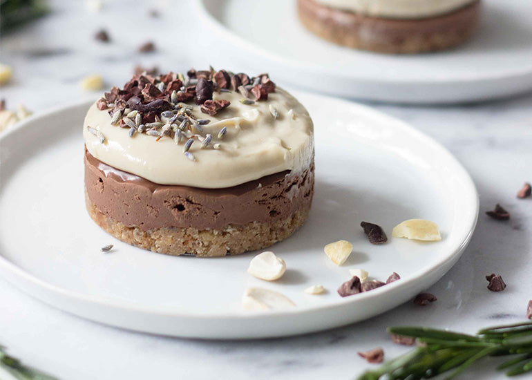 A mini layered chocolate vanilla cheesecake made with Navitas Organics Cacao Powder, Cacao Butter, Cacao Nibs and Cacao Sweet Nibs