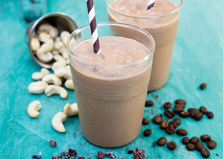 Two chocolate mocha smoothies made with Navitas Organics Cacao Powder and Cacao Nibs