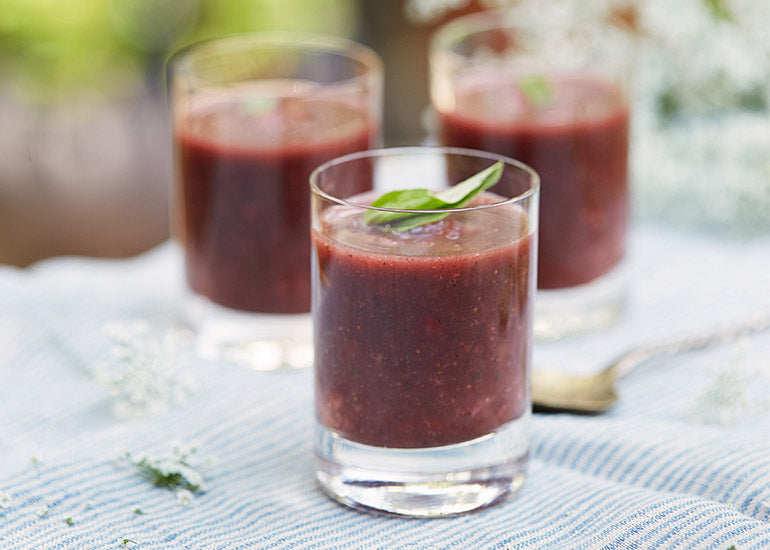 Three glasses filled with gazpacho made with Navitas Organics Acai Powder.