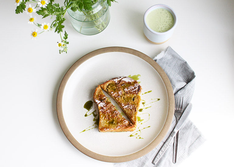 A plate of French toast drizzled with a matcha caramel sauce made with Navitas Organics Matcha Powder.